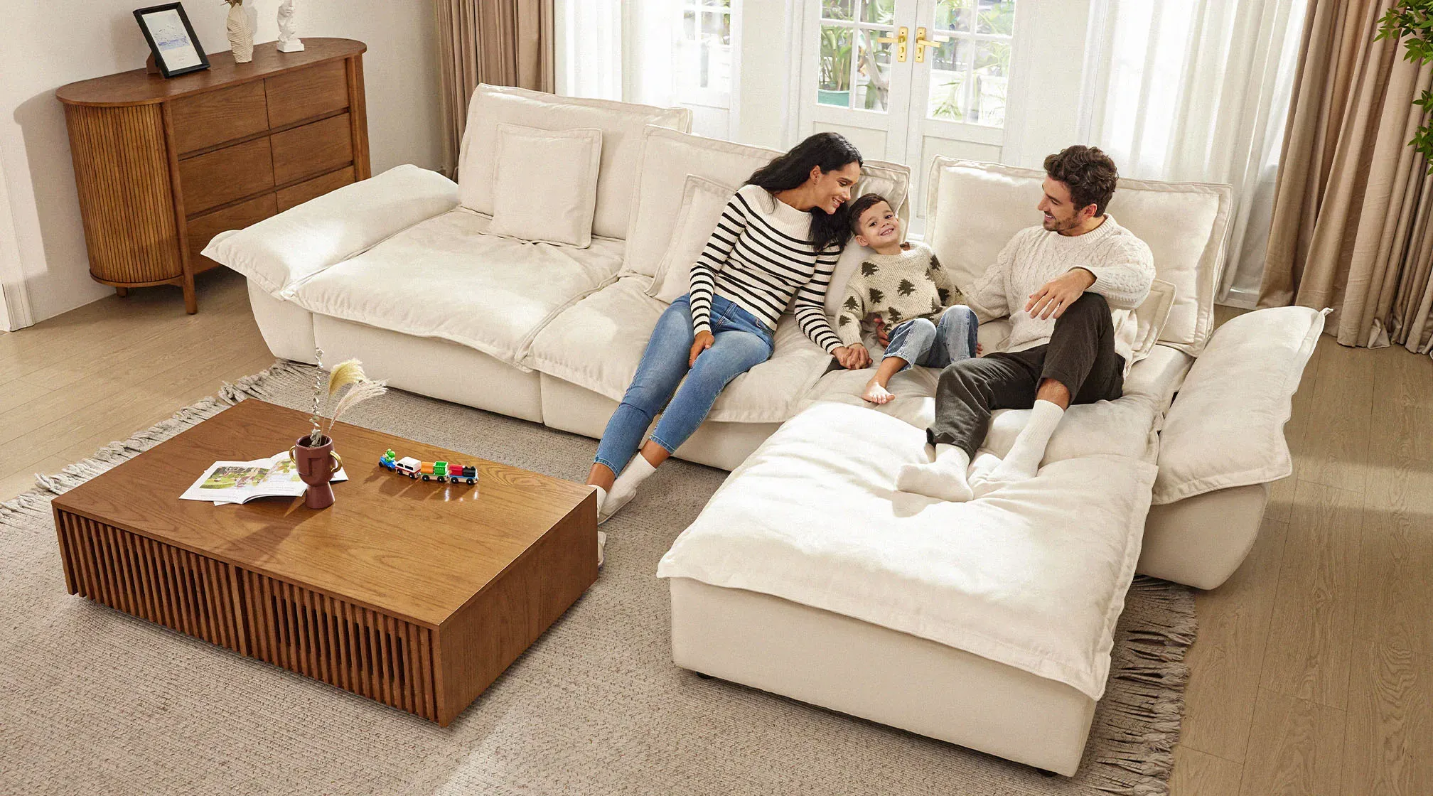 A Family of Three Sitting and Lounging on an Extra Deep Cloud Sectional Sofa from Povison