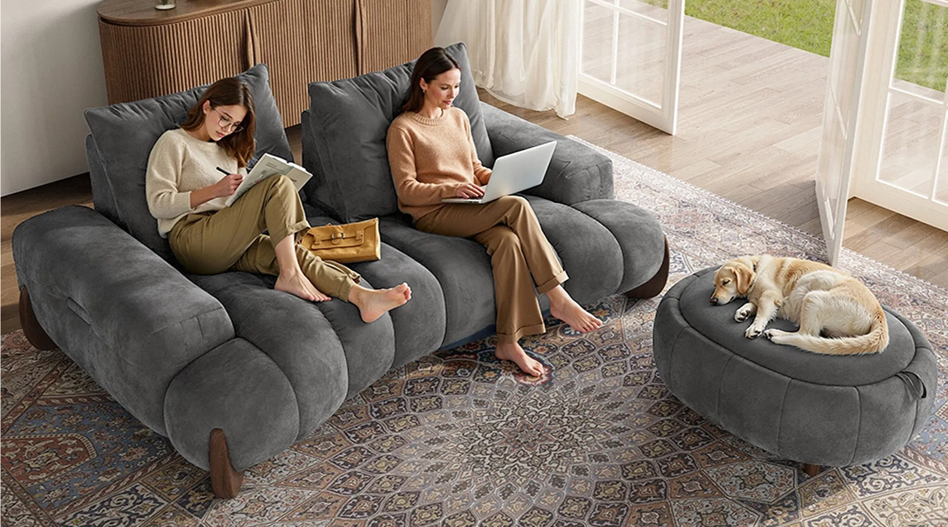 Two ladies lounge on an extra deep sofa that suitable for movie nights